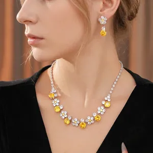 Elegant floral jewelry set featuring zircon earrings and necklace on a model