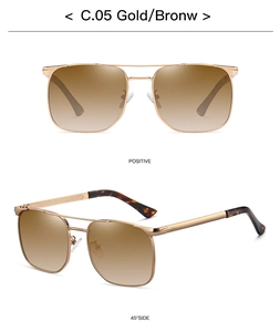 Detail view of gold aviator sunglasses with brown gradient lenses and metal frame