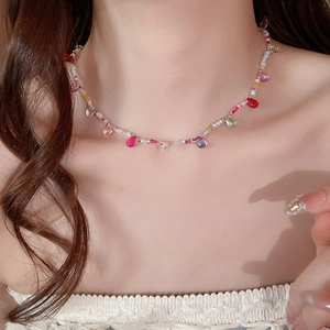 Close-up of colorful crystal resin bead necklace with water drop pendant on neck
