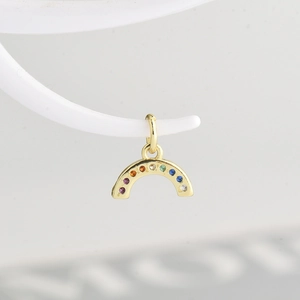 Macro shot of gold rainbow pendant with colorful micro-paved cubic zirconia stones