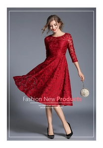 Close-up of vibrant red floral lace fabric and elegant hollow-out texture on dress