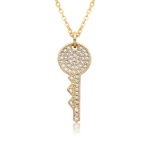 Macro shot of 18k gold heart key pendant featuring sparkling zircon micro-pave details