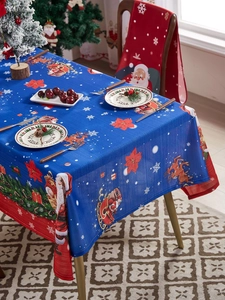 Blue Christmas tablecloth featuring Santa, reindeer, and snowflakes in a festive setting