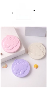 Close-up of portable folding mirrors with 3D bunny embossment in pastel colors