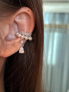 Detail view of silver ear cuff with pearls, micro-diamonds and waterdrop zircon pendant
