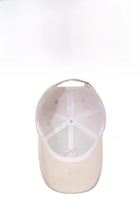 Detailed interior of beige cotton baseball cap showing six-panel stitching and inner lining