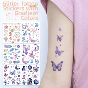Detail of glitter gradient tattoo stickers showing butterfly and moon patterns on skin