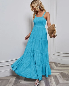 Detail of tiered lake blue striped maxi dress showing the layered fabric and light texture