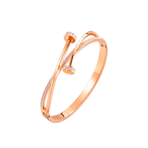 Macro detail of rose gold nail-style bangle with shimmering pave-set crystals
