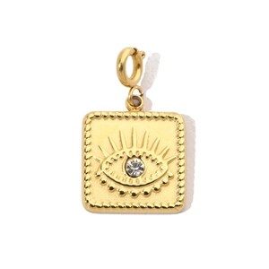Detail of a square gold pendant featuring an evil eye relief and a sparkling zircon stone