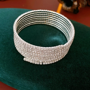 Close-up of a silver multi-layer spiral cuff bracelet with sparkling rhinestones