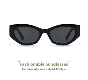 Flat lay macro of black cat-eye sunglasses with deep grey lenses on white background