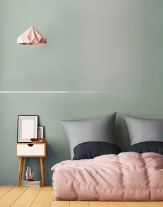 Detail of pink silent wall clock with gold 3D numbers on a mint green bedroom wall