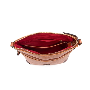 Detailed interior of brown pebbled leather crossbody bag with red lining and compartments