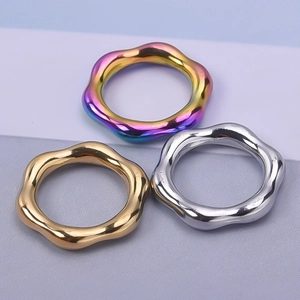 Three wave shaped metal rings in rainbow, gold, and silver finishes for DIY jewelry making