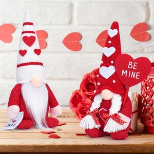 Close-up of Valentine Gnomes with SWAK card and Be Mine sign on a festive wooden table