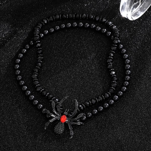 Double-layer black beaded necklace with a spider pendant featuring a red faceted gemstone