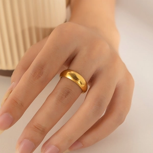 Detailed close-up of a minimalist 18k gold plated irregular geometric ring on a model