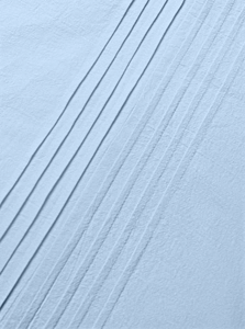 Macro detail of parallel pleats on light blue cotton linen men's casual shirt fabric