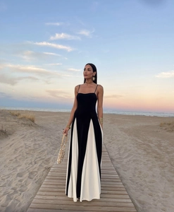 Detail of elegant black and white patchwork maxi dress with thin Italian shoulder straps