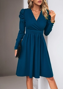 Detail of elegant V-neck dress with puff sleeves and cinched waist in dark cyan color