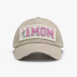 Detailed close-up of khaki washed cotton baseball cap featuring pink #1 MOM patch
