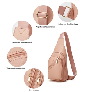 Detailed view of pink crossbody bag showing adjustable strap, reinforced seams and woven texture