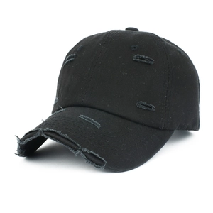 Close-up of distressed cotton baseball cap featuring worn details and a curved brim