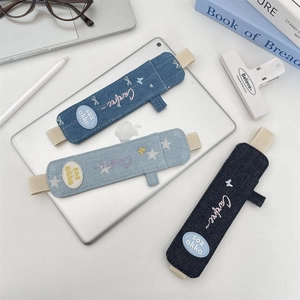 Three denim pencil pouches with elastic straps and embroidery shown on a tablet