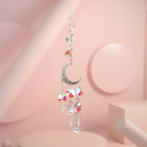 Detailed view of silver moon suncatcher with colorful crystal beads on pink background