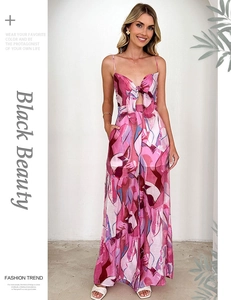 Detail of floral print jumpsuit featuring bow-tie V-neck and stylish waist cut-out