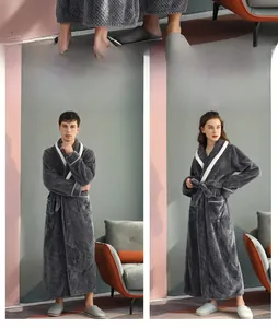 Detail showing thick waffle texture and white piping on dark grey flannel bathrobe