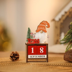 Close-up of wooden Christmas gnome countdown calendar with DIY date blocks on desktop