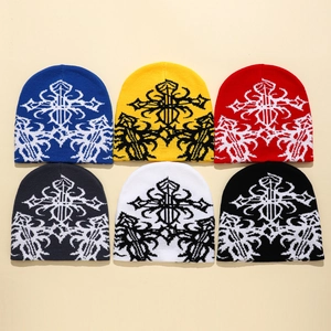 Flat lay of knit beanies in six colors featuring gothic cross pattern textures