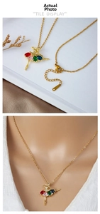 Detailed view of ballet girl pendant featuring colorful cubic zirconia and gold steel chain