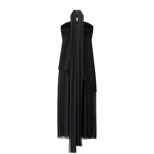 Detailed view of black tube dress featuring layered mesh hem and elegant chiffon flowing ribbons