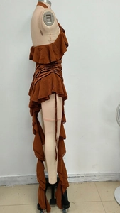 Detail of caramel ruffled halter dress featuring layered chiffon fabric and drawstring side