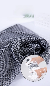 Detail of the 3D woven texture on a long exfoliating back scrubber for rich lather