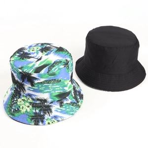 Close-up of reversible bucket hat set showing black and tropical palm leaf print canvas