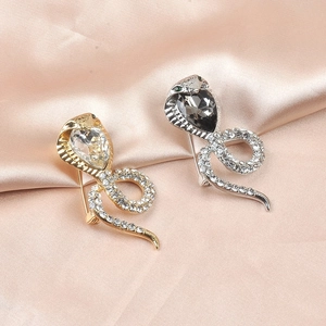 Elegant cobra snake brooches in gold and silver with sparkling teardrop crystals