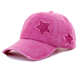 Detailed side view of pink washed denim baseball cap with glittery star patch
