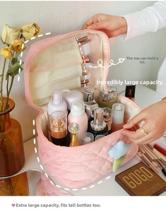 Pink corduroy makeup bag detail with brush slots and large main compartment storage