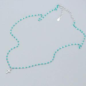 Detail of S925 sterling silver chain with turquoise beads and cross pendant