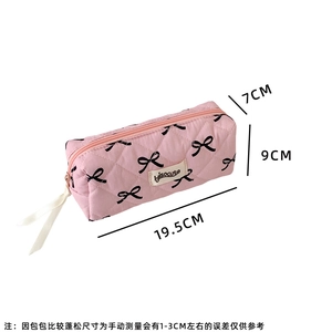 Detailed view of pink quilted storage bag with bow print and size 19.5x9x7cm