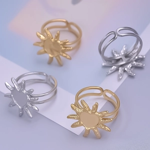 Detail of sun petal open rings with heart centers in gold and silver finishes