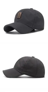 Detail of dark gray baseball cap with laser-cut ventilation holes and brown leather patch