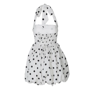 Detail of white halter neck dress with black polka dots featuring back drawstring tie closure