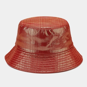 Macro detail of bucket hat with metallic red fabric texture and subtle vertical stripes