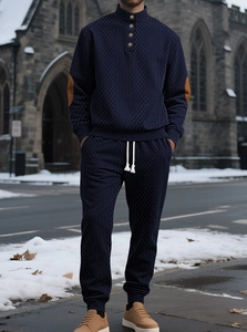 Detail of navy knit sweatshirt with half-zip stand collar and brown elbow patches