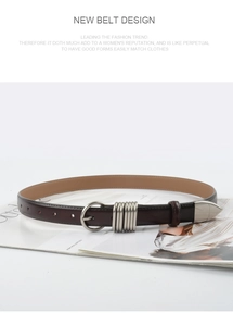 Close-up of a dark brown leather belt with a silver round buckle on a fashion magazine